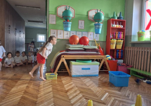 dziewczynka wrzuca woreczki do pojemnika