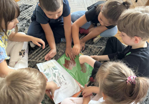Dzieci oglądają liście w albumie