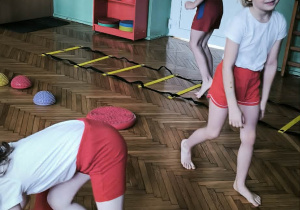 Chłopiec przeskakuje szczebelki drabinki gimnastycznej