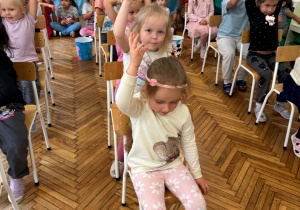 Dzieci podają sobie piłeczkę nad głową