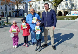 Pani dyrektor pozuje do zdjęcia z rodzicem oraz dziećmi z nszego przedszkola