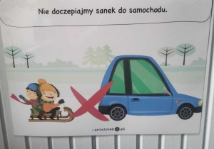 ilstracja przedstawiająca dzieci na sankacch, które jadą za blisko samochodu