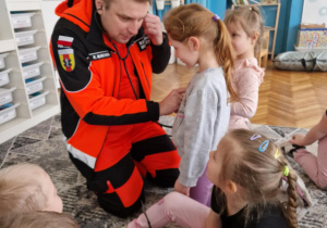 Ratonik medyczny bada stetoskopem dziewczynkę