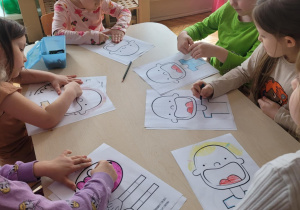 Dzieci koloruja pączki i postać chłopca