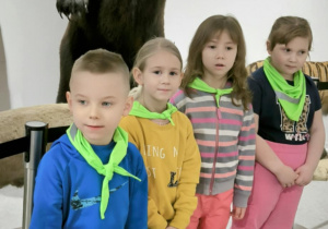 Dzieci stoją na tle niedźwiedzia
