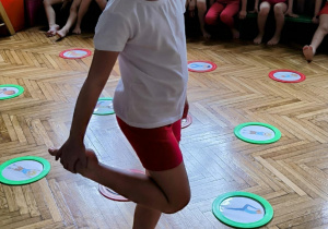 Dziewczynka stoi na jednej nodze