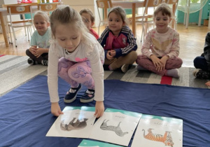 Dziewczynka kladzie ilustrację słonia