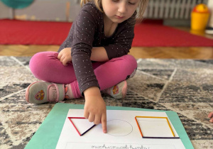 Dziewczynka palcem pokazuje koło