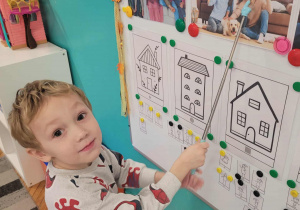 Chłopiec wskazuje na ilustracji tatę