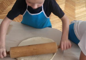 Chłopiec wałkuje ciasto