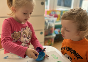 Dziewczynka nakłada niebieską farbę