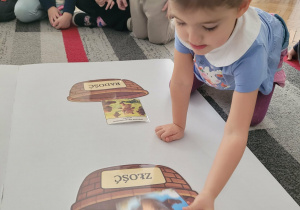 Dziewczynka kładie obrazek złego misia