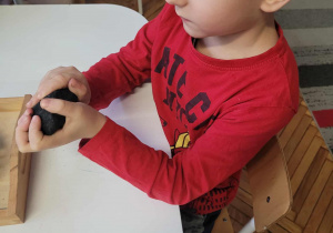 Chłopiec z bryłką węgla