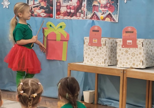 Dziewczynka opowiada obrazek z piszącym list chłopcem