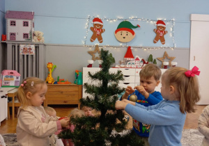 Dzieci ubierają choinkę