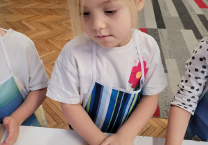 Dziewczynka ugniata ciasto na pierniki