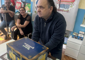 Dziadek wyciąga coś z magicznego pudełka