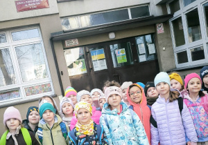 Dzieci stoją przez szkołą