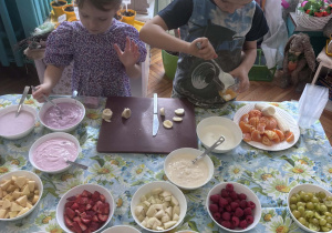 Dzieci wlewają jogurt do pojemniczków