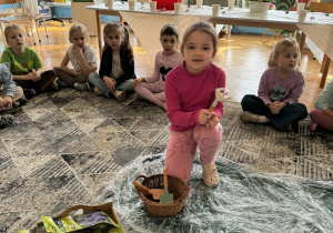 Dziewczynka trzyma w reku grabki ogrodnicze