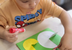 dziecko wykonuje pracę plastyczną kura i kurczak