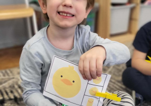 dzieci pokazuja plansze z ćwiczeniem