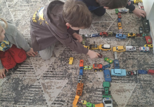 Chłopcy bawią się autkami