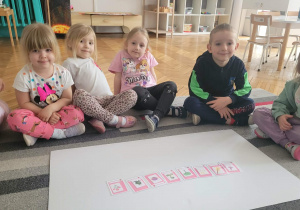 Dzieci siedzą z ułożonymi obrazkami i cieniami