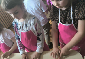 Dziewczynki przy stole układają flagę Polski